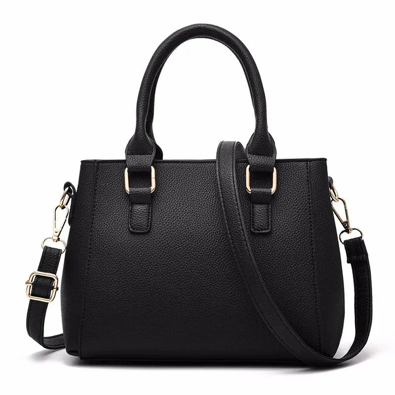 Black handbag with gold hardware on a white background