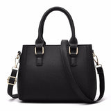 Black handbag with gold hardware on a white background