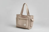 Beige handbag on a denim jacket with a white background