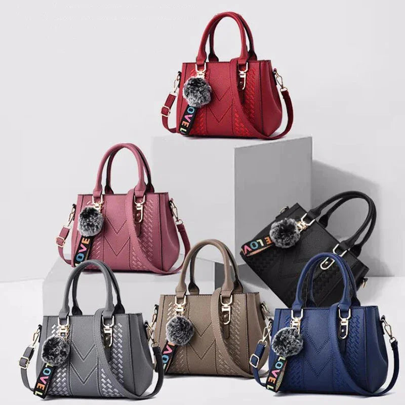 Collection of handbags in various colors with decorative pom-poms on a white background