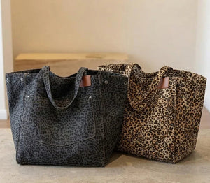 Two tote bags with leopard print pattern on a neutral background
